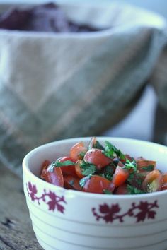 a white bowl filled with chopped vegetables on top of a wooden table