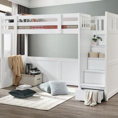 a white bunk bed sitting on top of a wooden floor