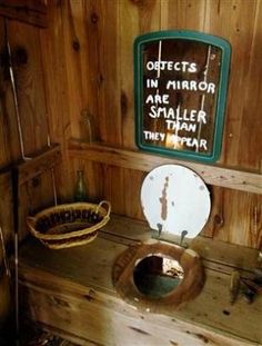 there is a toilet in the bathroom with wood paneling on the walls and floor