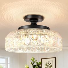 a chandelier hanging from the ceiling in a living room