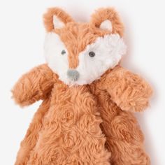 a small stuffed fox is shown on a white background