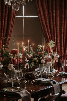 a dining room table with candles and flowers on it