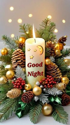 a lit candle surrounded by pine cones and christmas decorations with the words good night written on it