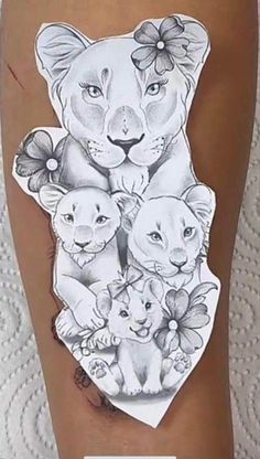 a woman's leg with tattoos on it and an image of two lions in the center