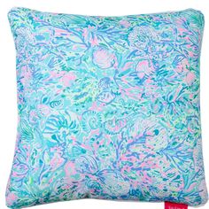 a blue and pink pillow on a white background