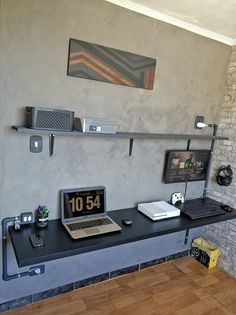 a laptop computer sitting on top of a desk next to a clock and other items