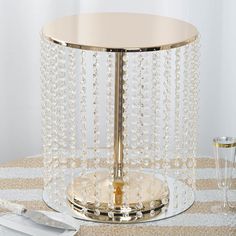 the table is set with silverware and an elegant glass candle holder on top of it