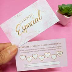 someone is holding up a business card with gold hearts on the front and bottom, which reads cliente special