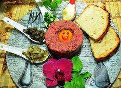 a plate topped with meat, bread and vegetables