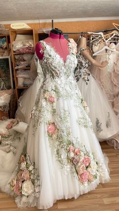 wedding dresses are on display in a store