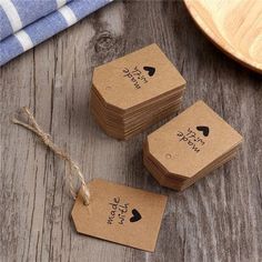 four small brown tags with black hearts on them