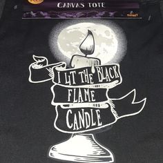 a black t - shirt with the words, it's the black flame candle