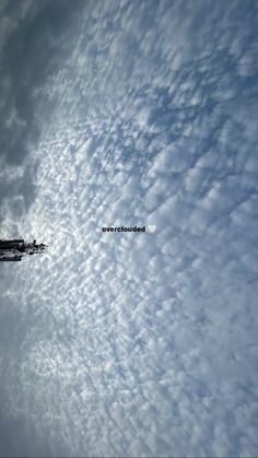 an airplane is flying through the clouds in the sky