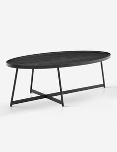 a black table sitting on top of a white floor next to a wooden table with metal legs