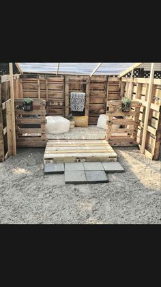 an outdoor area with wooden pallets and plants