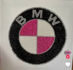 the bmw logo is made out of sequins and has been embroidered onto it