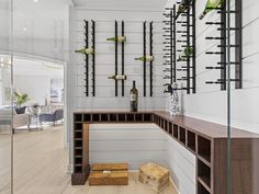 a room that has some shelves on the wall with bottles and wine glasses in it