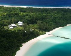 an aerial view of a tropical island with white sand and blue water