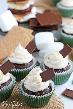 chocolate cupcakes with marshmallows and graham crackers on the side