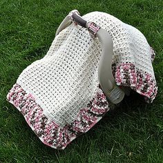 a crocheted blanket laying on the grass