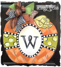 a decorated pumpkin with the letter w on it