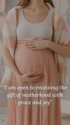 a pregnant woman holding her belly with the caption i am open to receiving the gift of motherhood with grace and joy