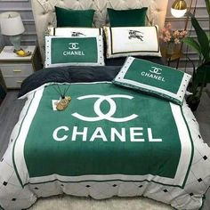 a chanel bed set with green and white sheets