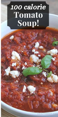 a white bowl filled with tomato sauce and feta cheese