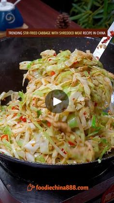 a pan filled with coleslaw and vegetables on top of a stove burner