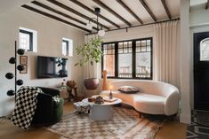 a living room filled with furniture and a flat screen tv on top of a wall