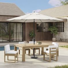 an outdoor dining table with chairs and umbrella next to a swimming pool in front of a house