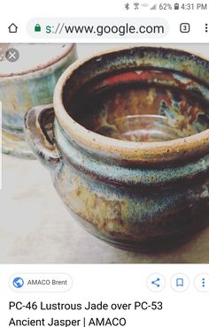 two old pots sitting on top of a table