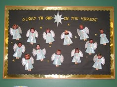 a bulletin board with angels and stars on it that says glory to god in the highest