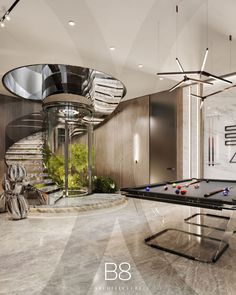 a pool table sitting in the middle of a room next to a spiral stair case