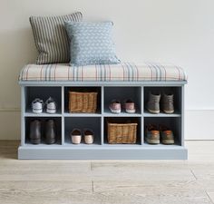 a blue bench with baskets and pillows on it