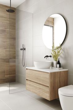 a bathroom with a sink, mirror and shower in it's centerpieces