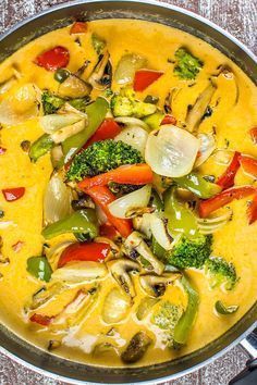 a pan filled with vegetables on top of a wooden table