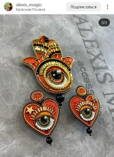 three brooches that have been made to look like hamsaas and eyeballs