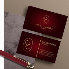 the business card is designed to look like it has a gold letter on it and an elegant red pen