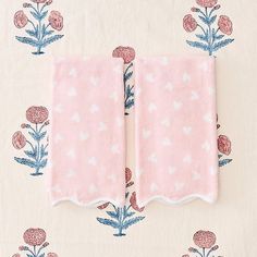 two pink towels with blue flowers on them