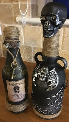 two bottles that have been decorated with skulls on them and rope wrapped around the top