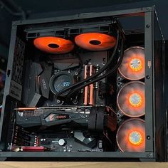 the inside of a computer case with four orange lights on it's sides and two fanless fans