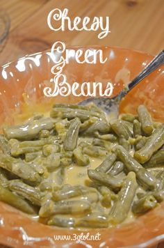 a bowl filled with green beans on top of a wooden table