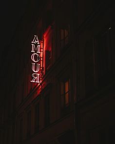 an illuminated sign on the side of a building