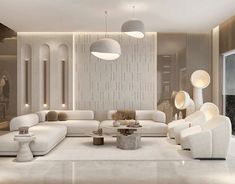 a living room filled with white furniture and lamps