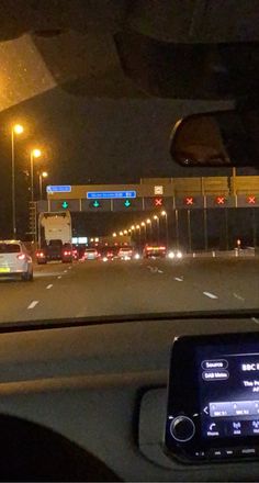 the dashboard of a car on a busy highway at night