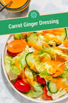 carrot ginger dressing in a white bowl with lettuce, tomatoes and cucumbers