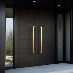 the front door to a modern house with two large doors and sidelights on either side