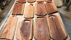 several wooden cutting boards sitting on top of a table