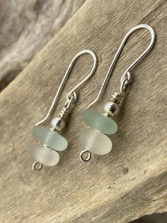 sea glass and sterling earrings on a piece of wood